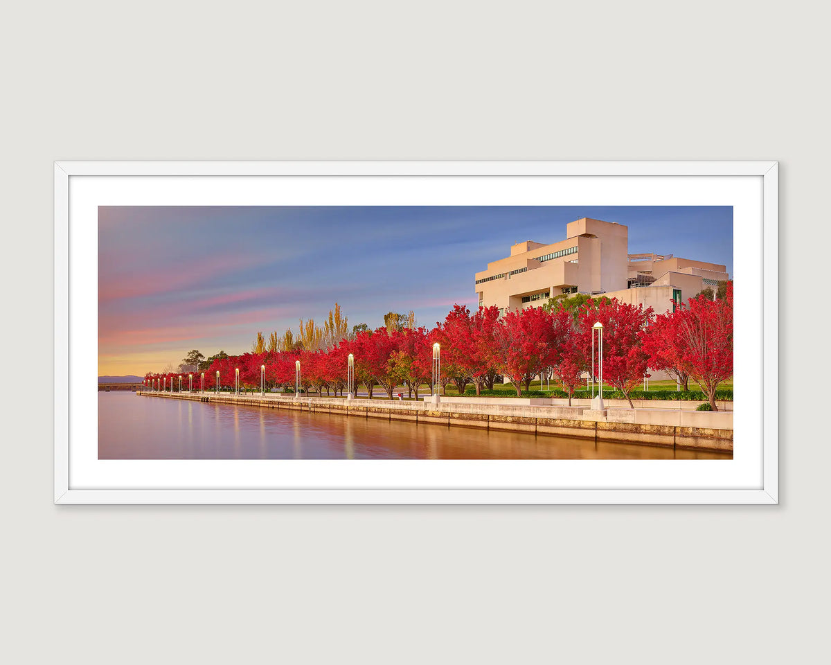 Framed panoramic photo of a The High Court of Australia with red trees and Lake Burley Griffin.