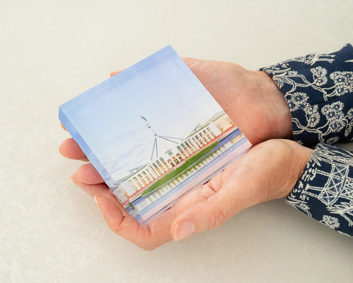 The Hill. Acrylic block of Parliament House Canberra, held in hands.