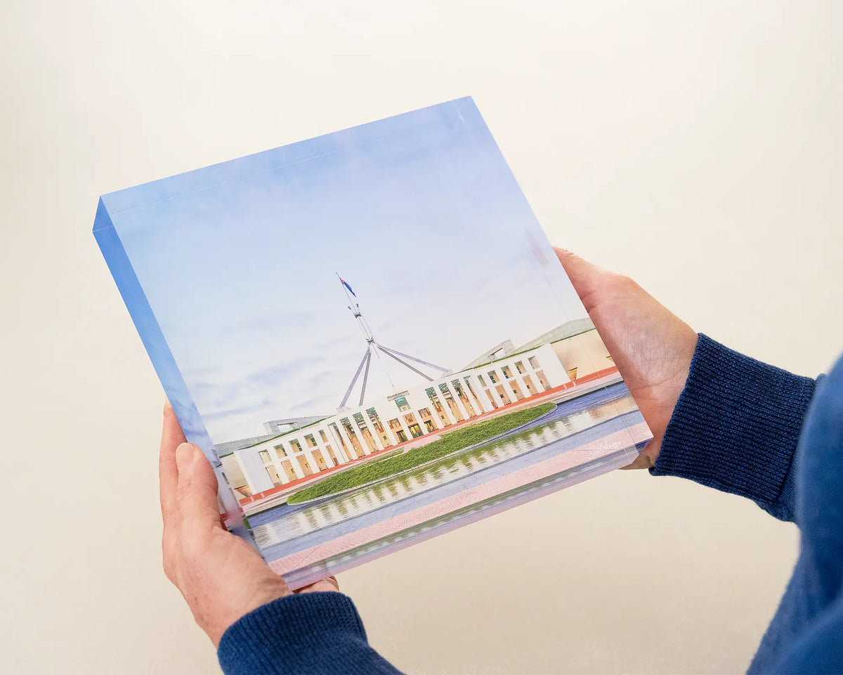 The Hill. Parliament House Canberra acrylic block being held in hands.
