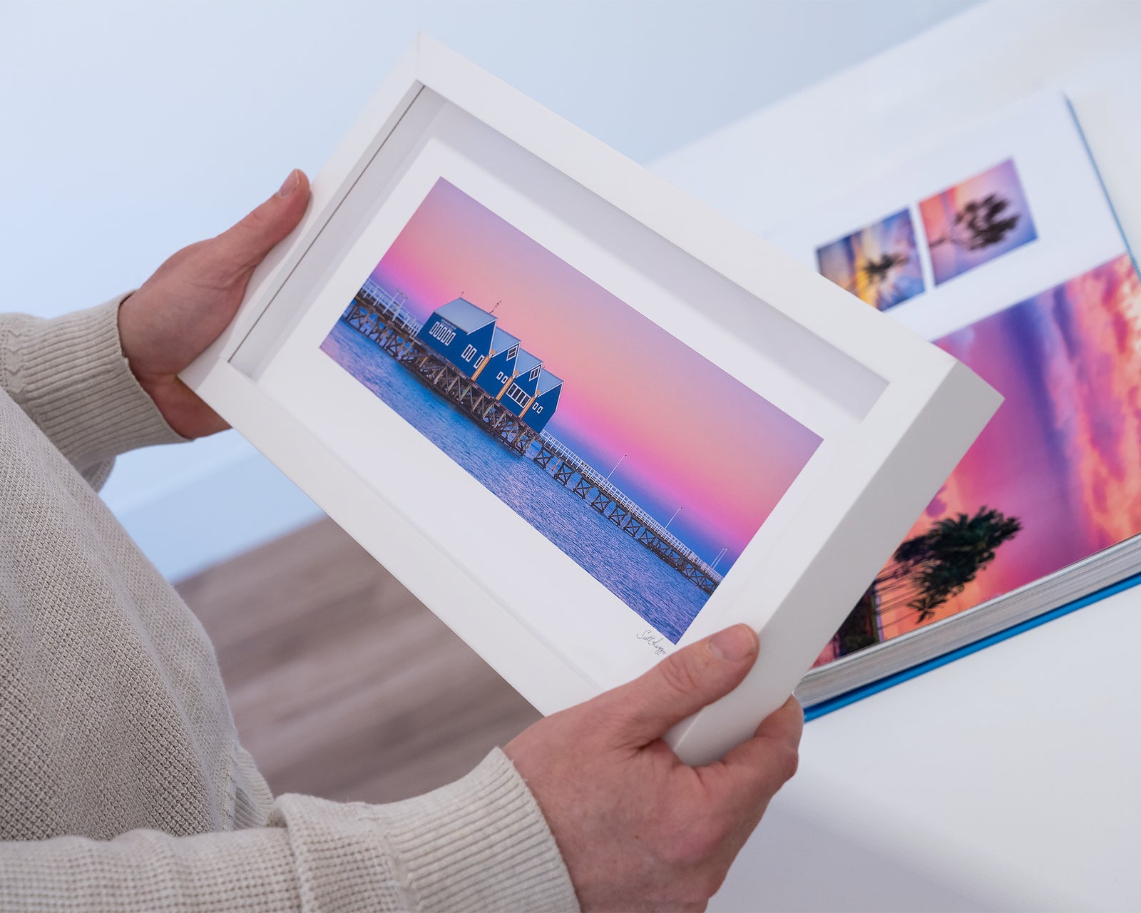 Framed artwork of Busselton Jetty, on a pier with a pink and purple sky.