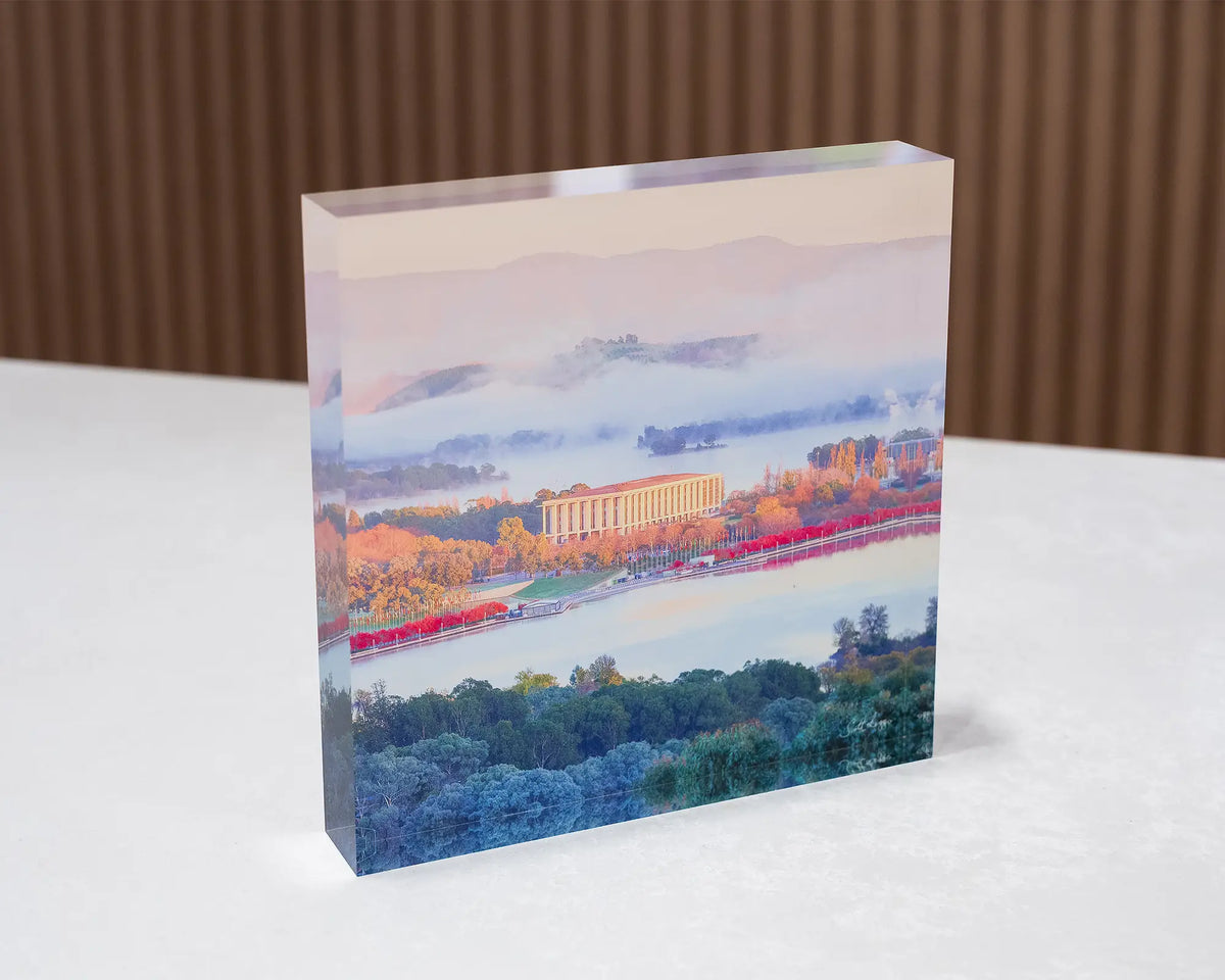 The Library. Acrylic block of the National Library of Australia, Canberra, in autumn fog, sitting on a desk.