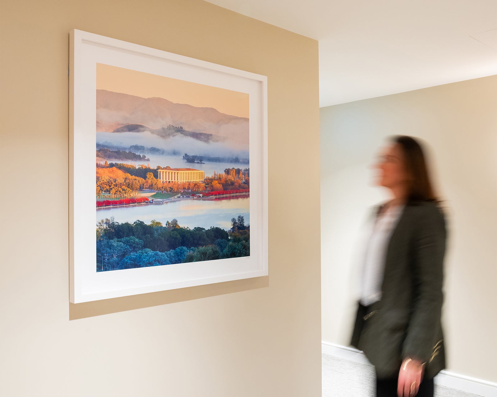 Framed artwork of a scenic landscape with The National Library of Australia, a lake and mountains.