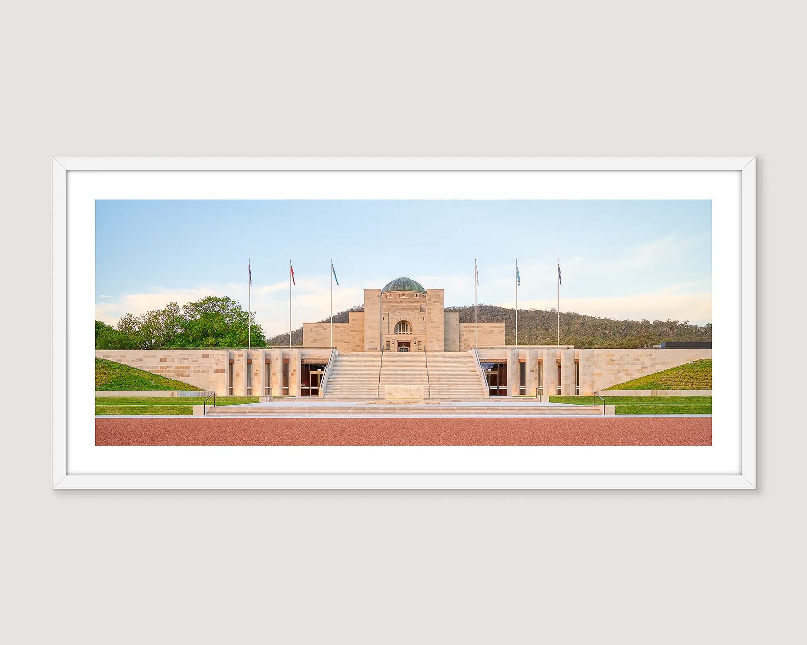 Framed photograph of the Australian War Memorial, surrounded by greenery and mountains.