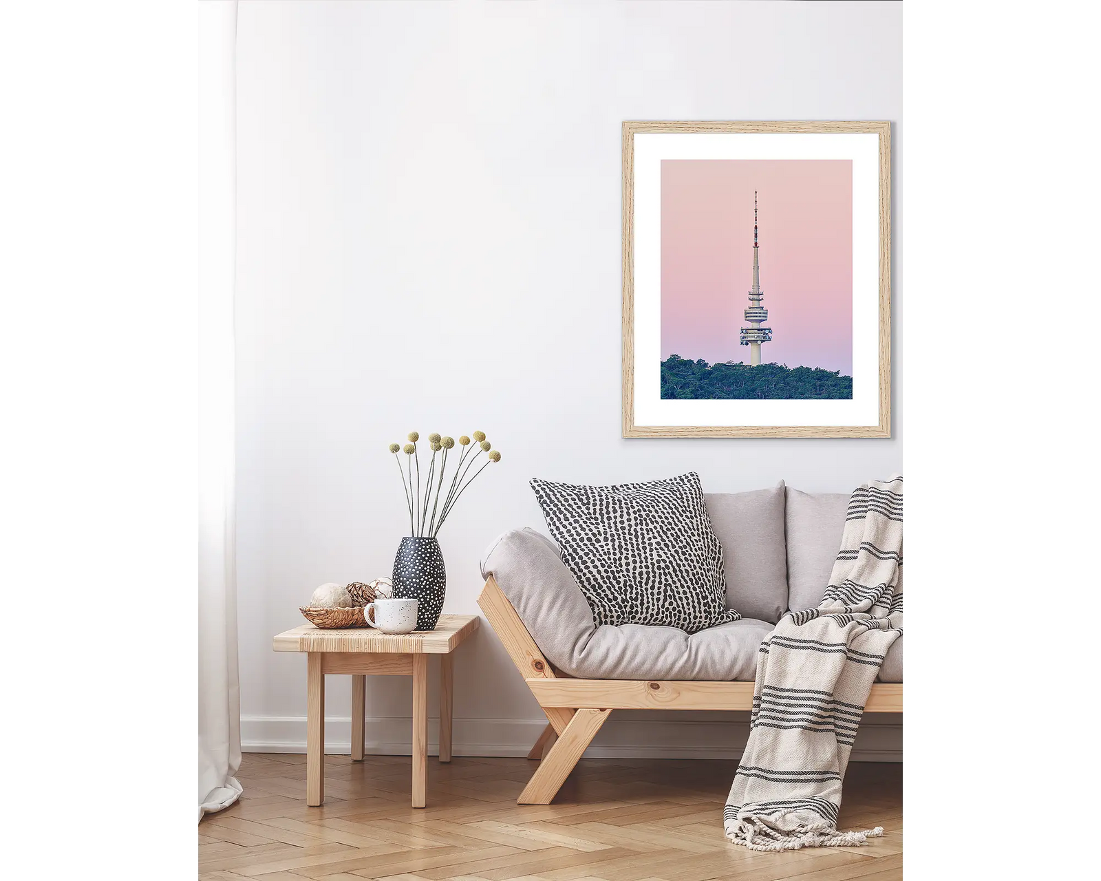 Framed artwork of Telstra Tower against a pink sky with green trees below