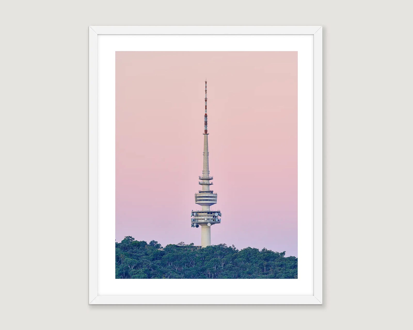 Framed artwork of Telstra Tower against a pink sky with green trees below