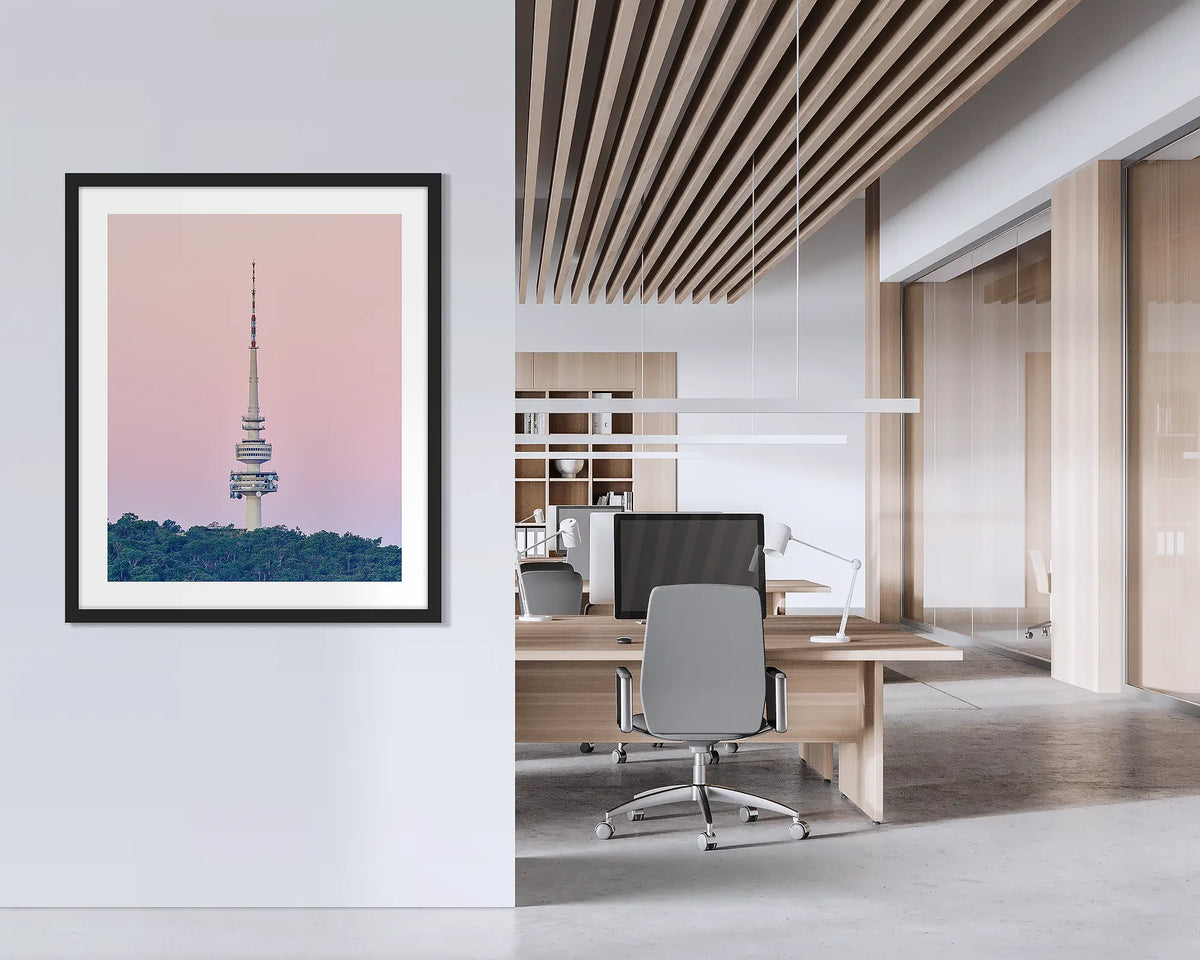 The Needle. Framed wall art print of Black Mountain Tower, with a black frame, hung on an office wall. 