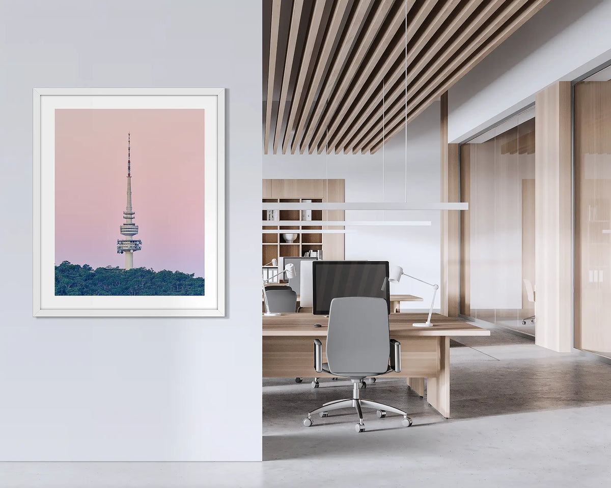 The Needle. Framed wall art print of Black Mountain Tower, with a white frame, hung on an office wall. 
