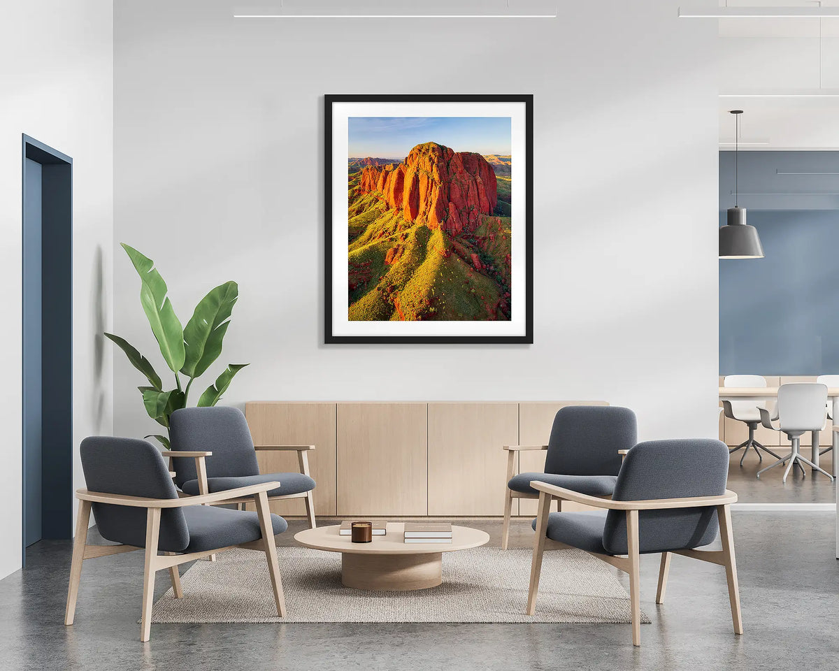 The Rock. Wall art print of Ragged Range at sunset in the Kimberley, with a black frame hung in a reception area. 