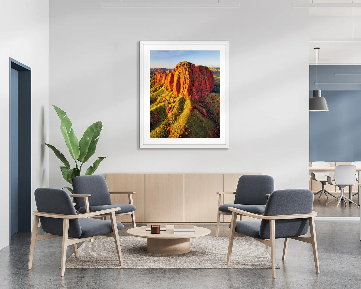 The Rock. Wall art print of Ragged Range at sunset in the Kimberley, with a white frame hung in a reception area. 