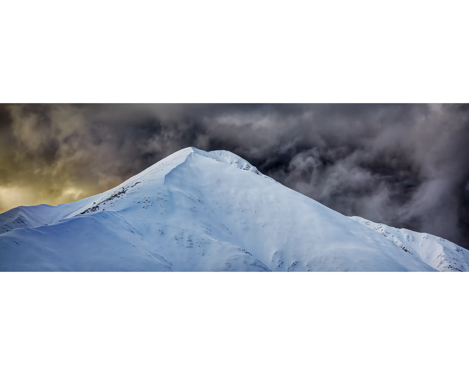 Dark storm clouds over the summit of Mount Feathertop, Alpine National Park, Victoria. 