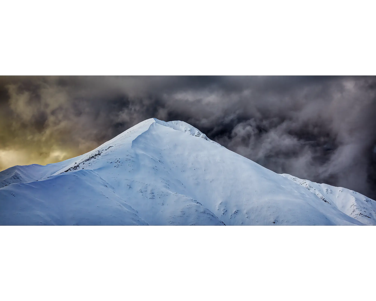 The Summit. Mount Feathertop with snow and dark clouds, Alpine National Park, Victoria, Australia.