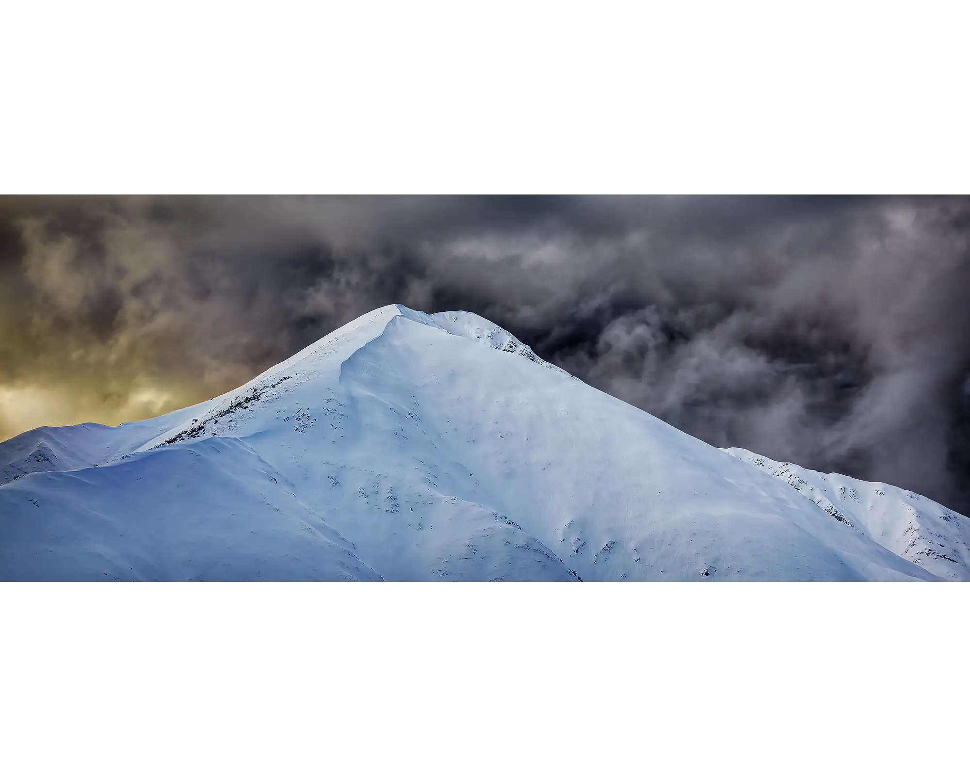 The Summit. Mount Feathertop with snow and dark clouds, Alpine National Park, Victoria, Australia.