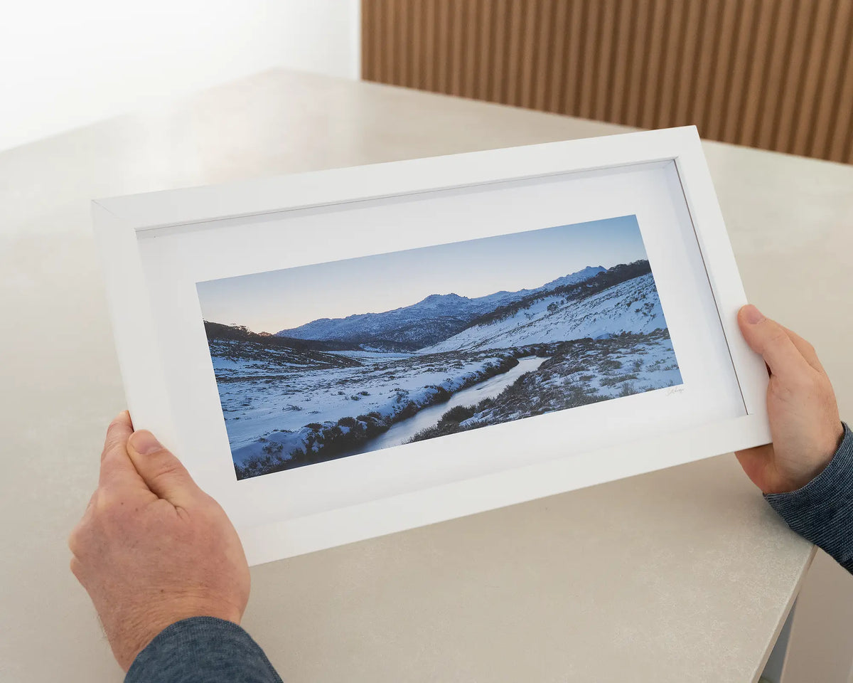 Thredbo Colours. Small framed print of sunset over Thredbo river hand held in the gallery.