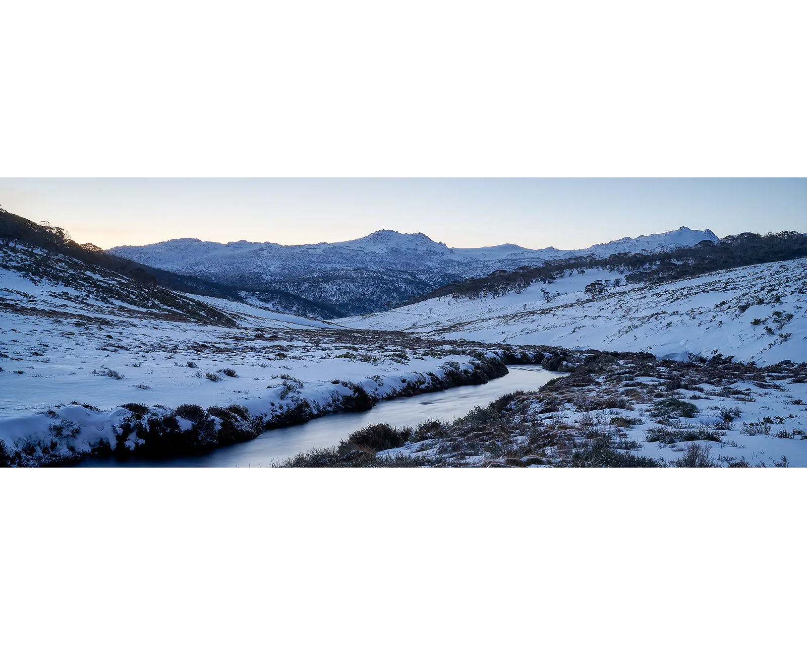 Thredbo Colours. Sunset over the Thredbo River and Rams Head Range with winter snow.