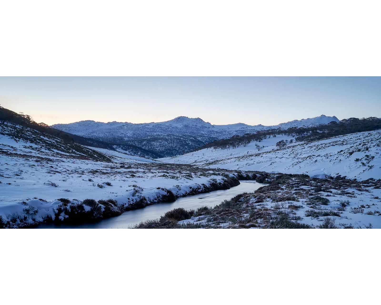 Thredbo Colours. Sunset over Thredbo River and Rams Head Range with winter snow.