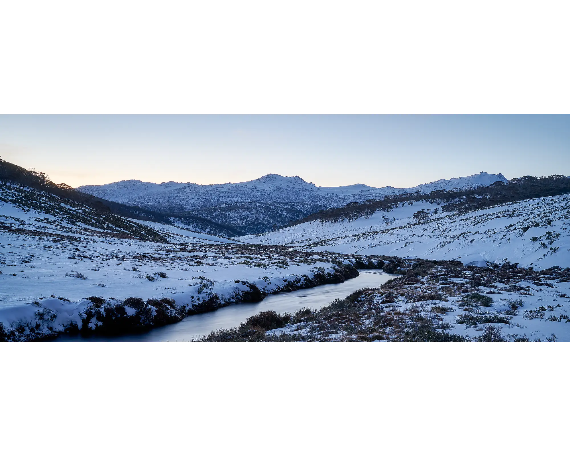 Thredbo Colours. Sunset over Thredbo River and Rams Head Range with winter snow.