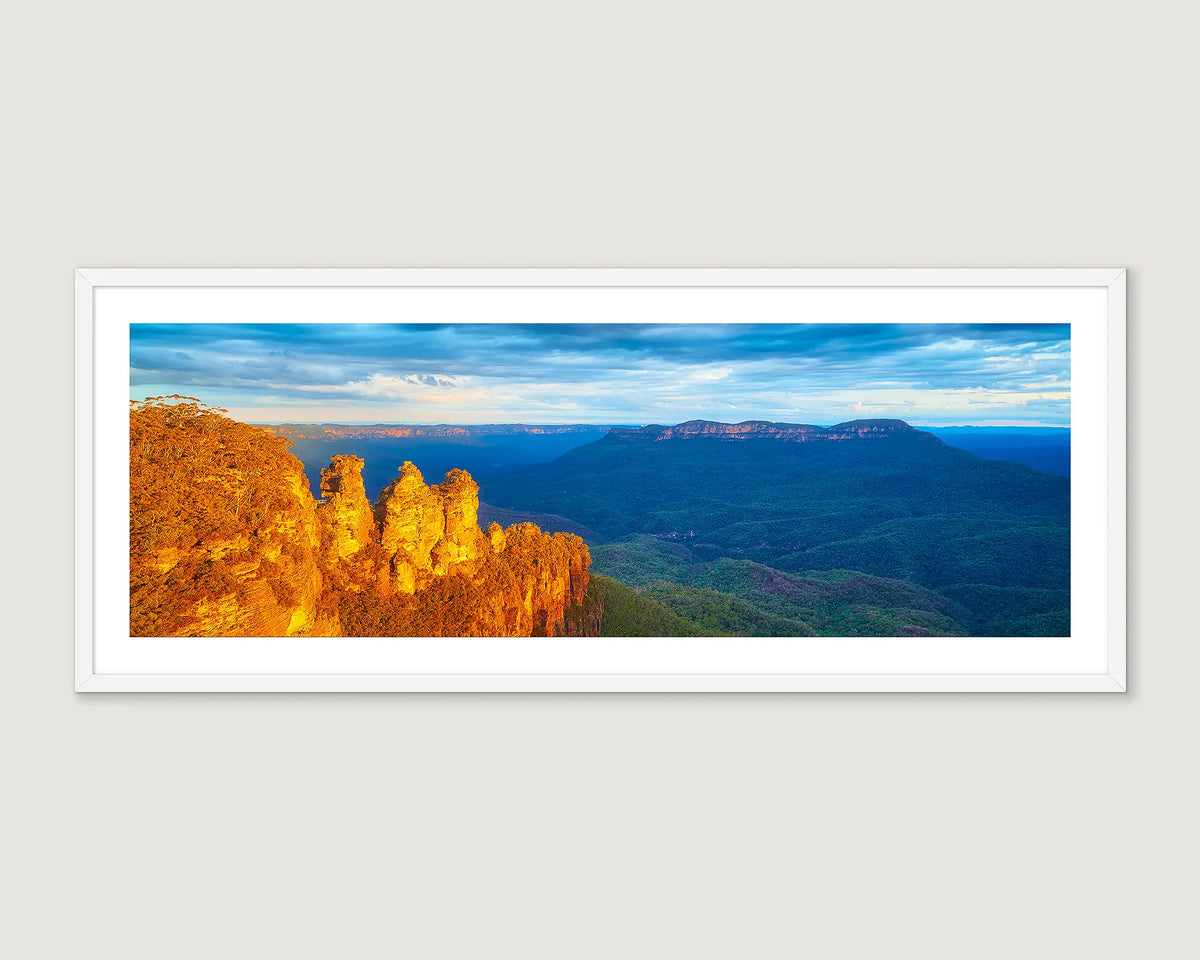 Framed panoramic landscape of the Three Sisters in the Blue Mountains with a blue sky.