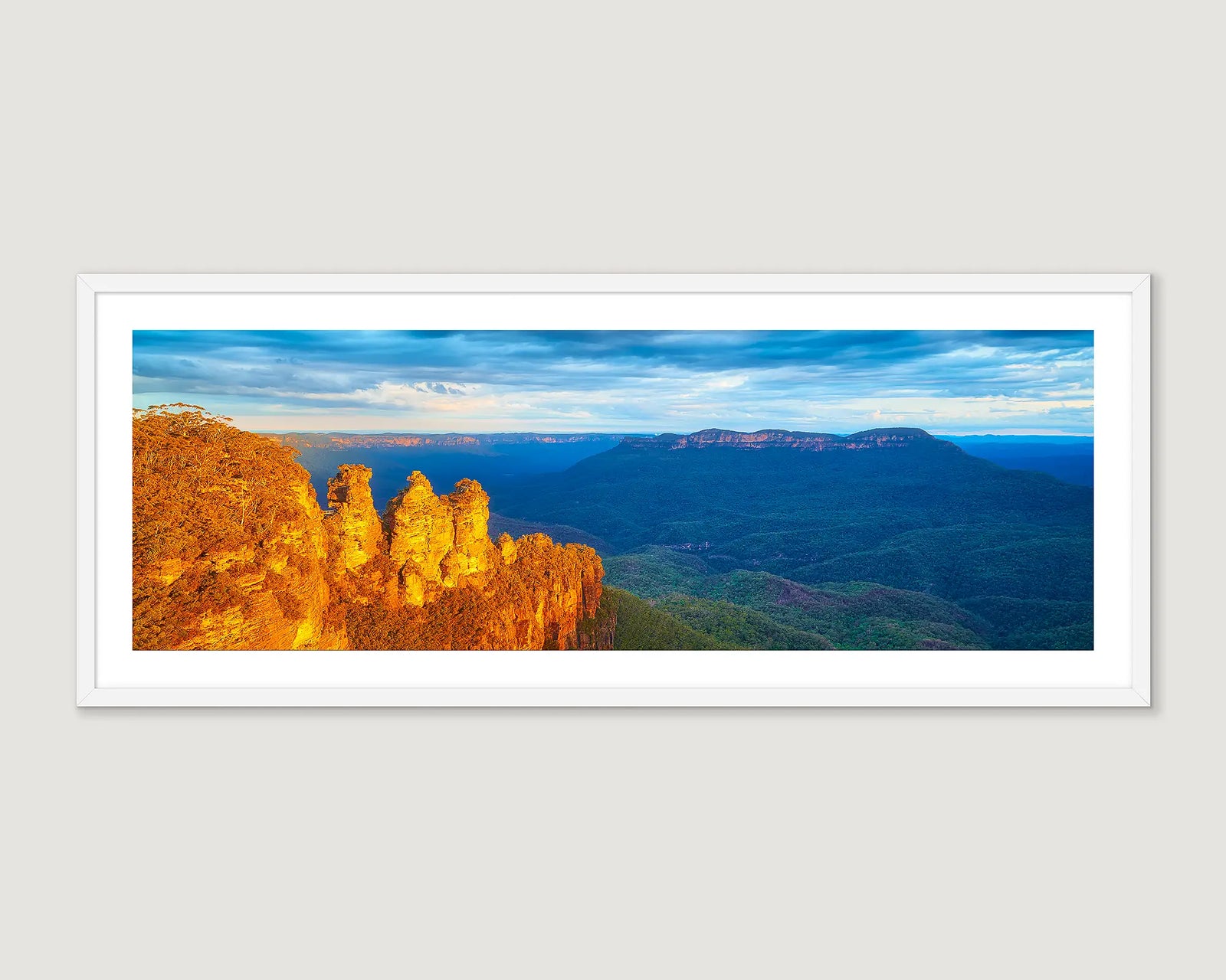 Framed panoramic landscape of the Three Sisters in the Blue Mountains with a blue sky.