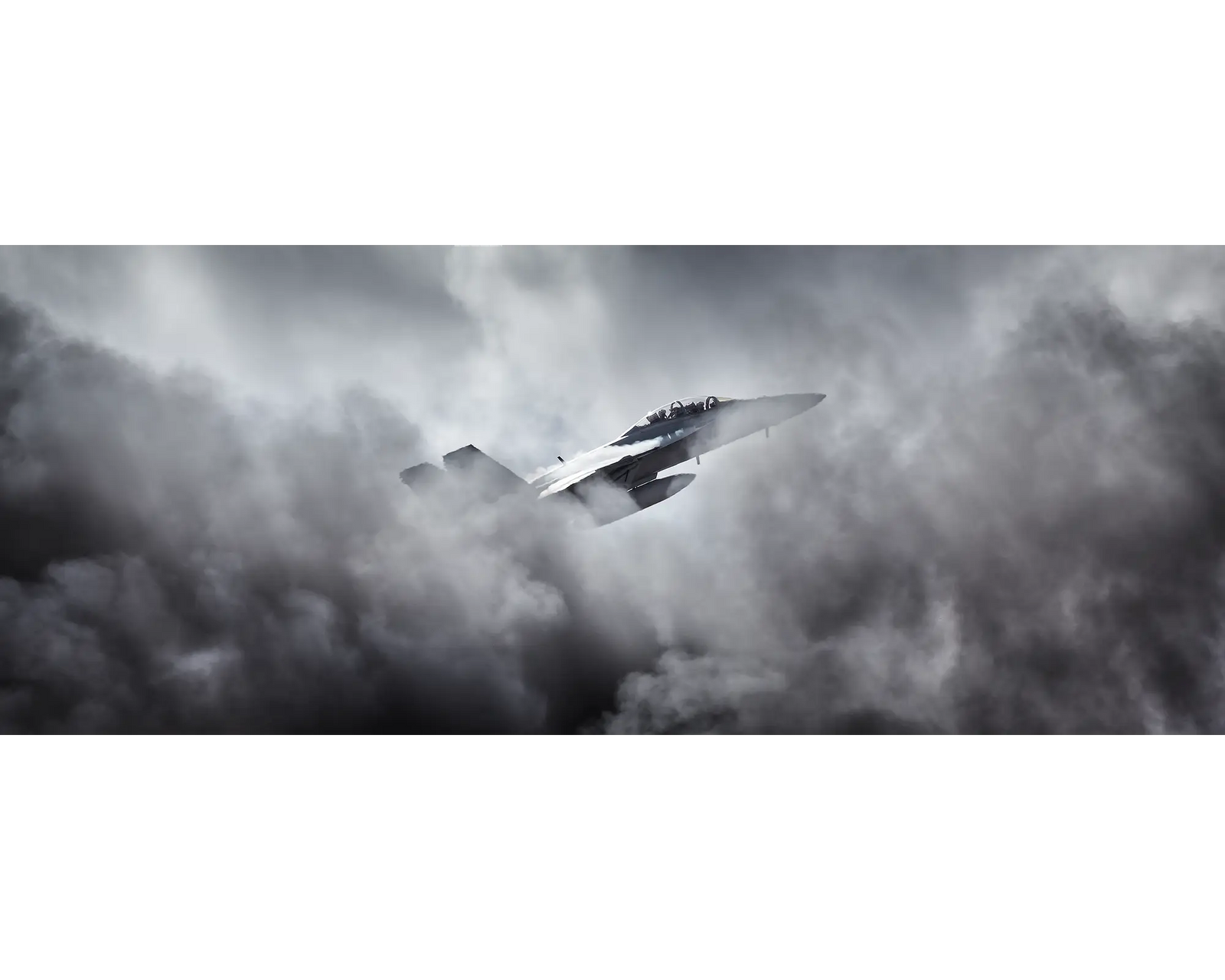 Australian Aior Force F/A-18F Super Hornet flying through clouds.