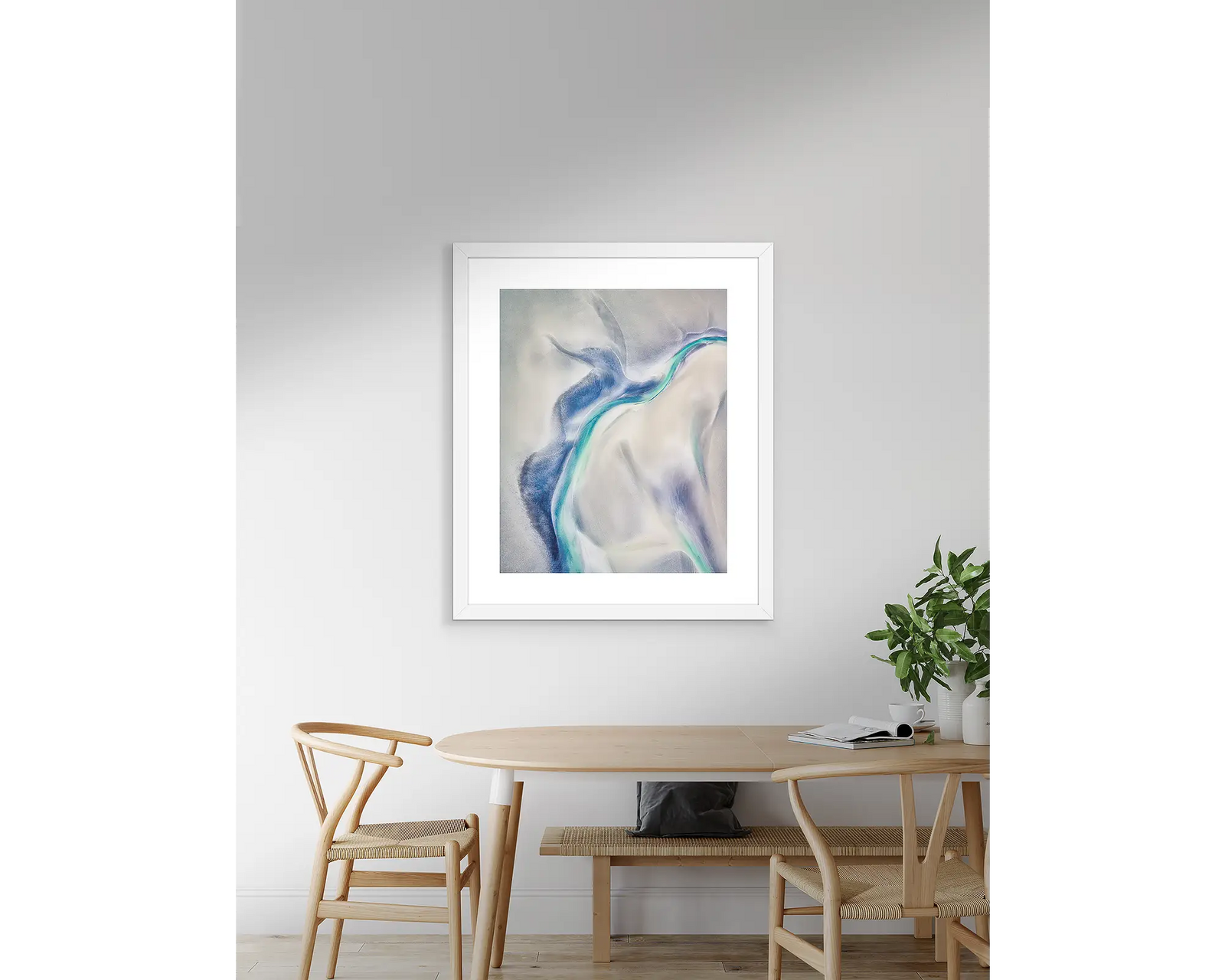 Framed abstract art print with blue and white colours on a light grey background.
