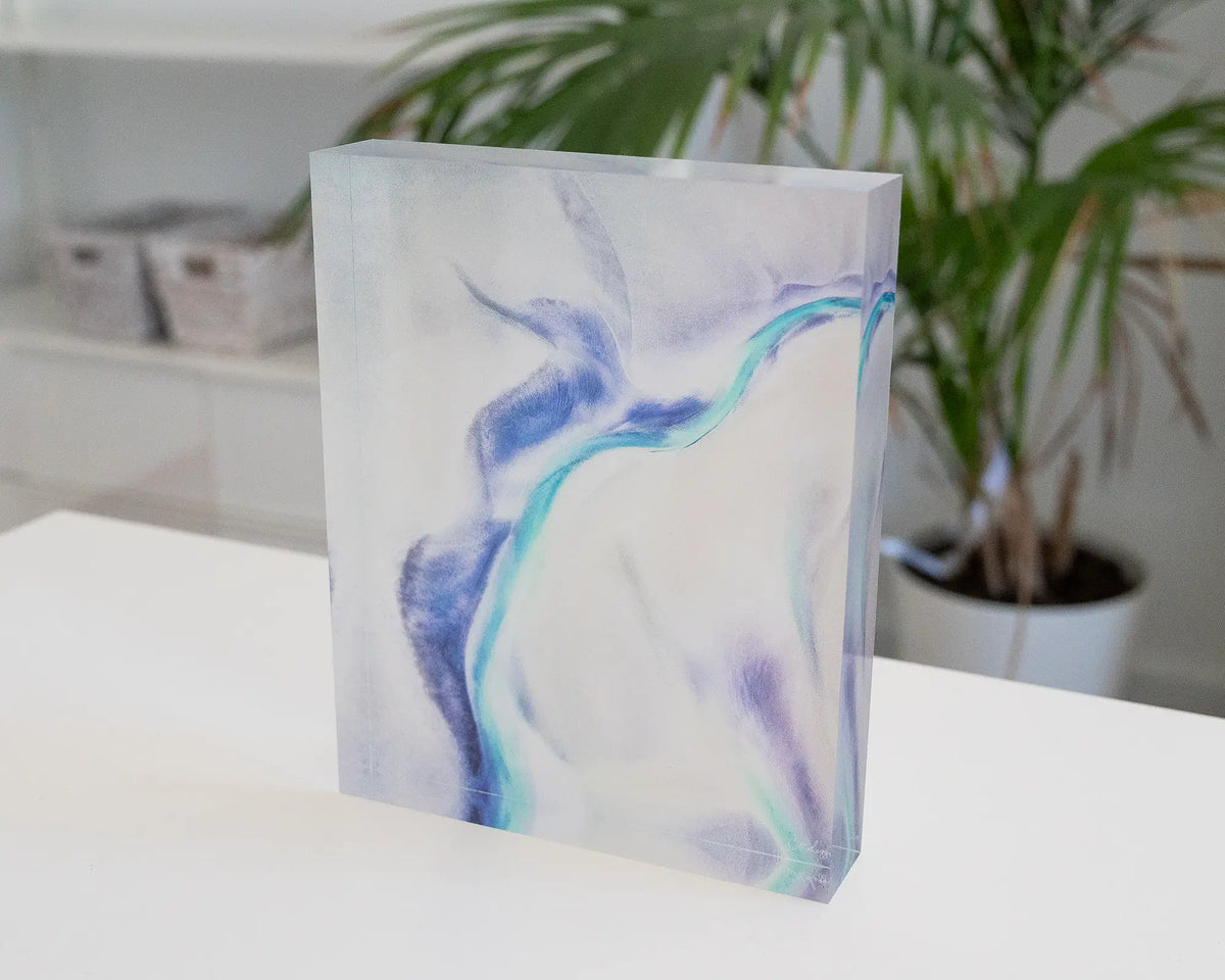 Tidal Orchid. Acrylic block abstract aerial artwork Roebuck Bay, Western Australia, on desk in a coastal home.