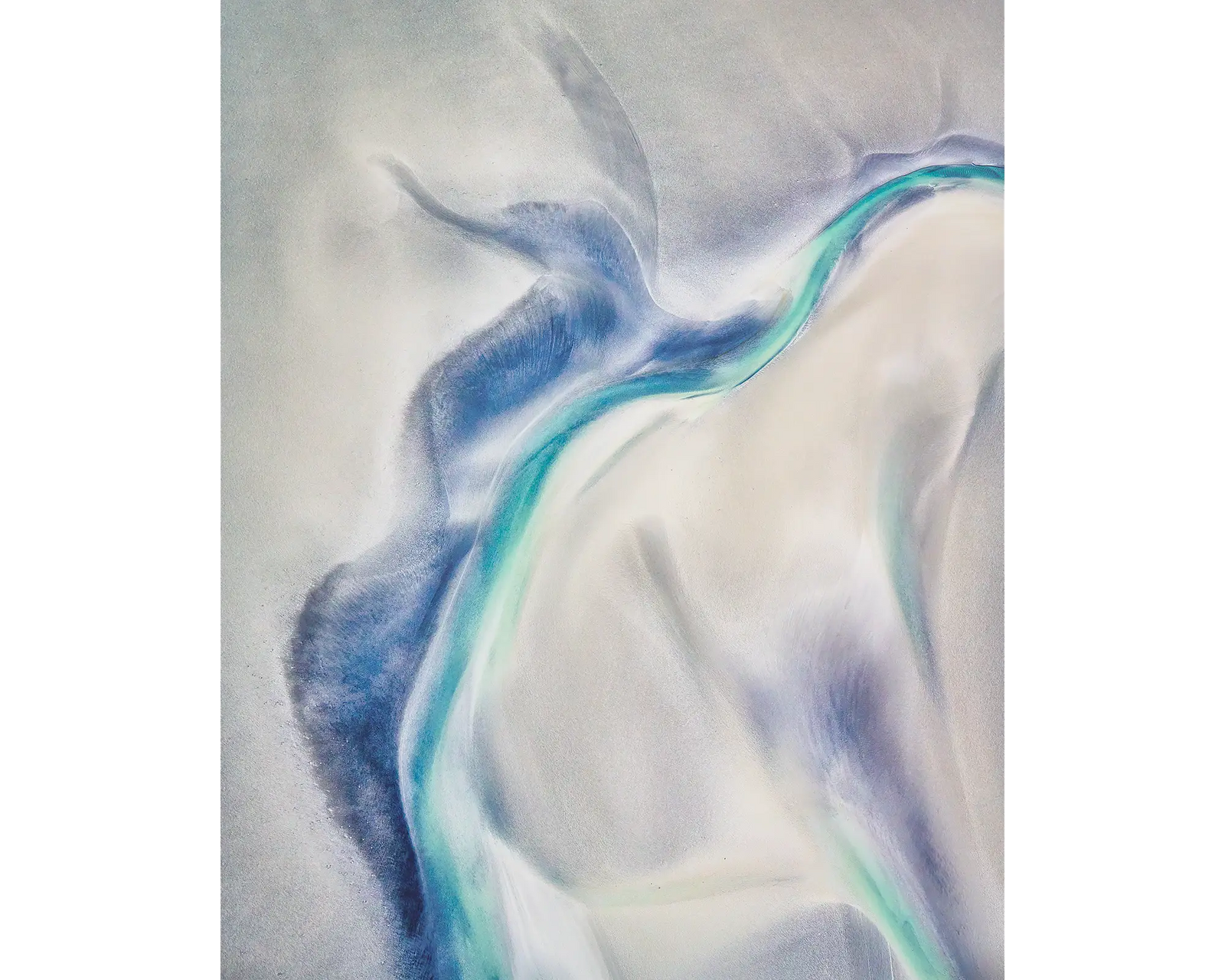 Tidal Orchid acrylic block displayed on a desk. White and blue tidal patterns in Roebuck Bay viewed from above, the Kimberley, WA. 