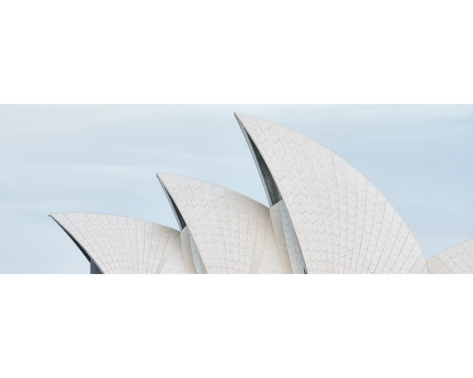 Close-up of the Sydney Opera House with a clear blue sky background