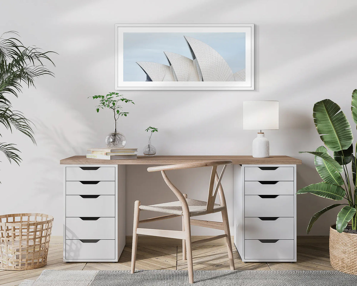 Tile Geometry. Wall art print of the Sydney Opera House, with a white frame, hung above a home office desk. 