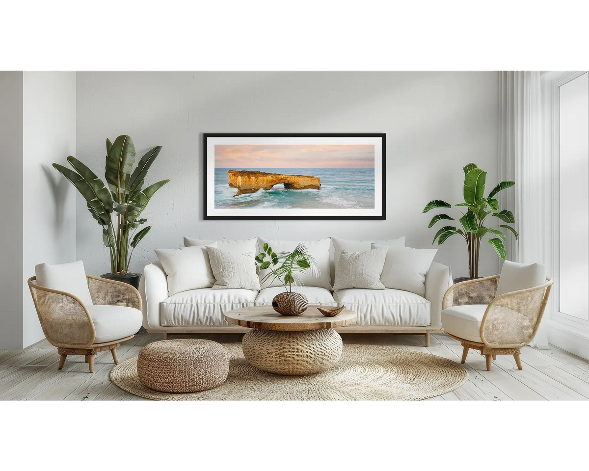 Time Out. Large wall art print of London Bridge, with a black frame, hung above a couch. 