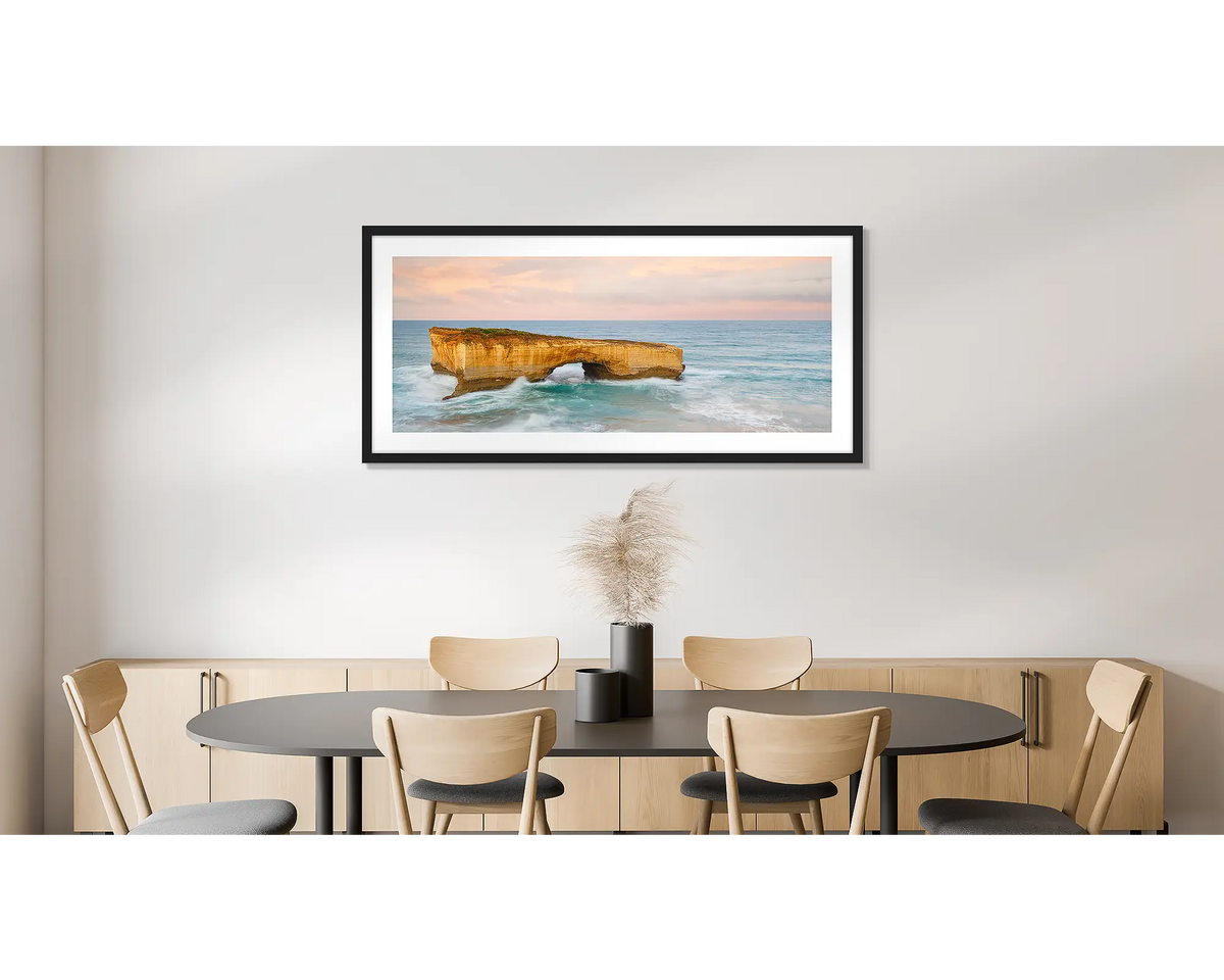 Time Out. Large wall art print of London Bridge, with a black frame, hung in a dining room. 