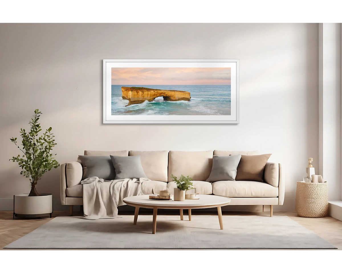 Time Out. Large wall art print of London Bridge, with a white frame, hung above a lounge room couch. 