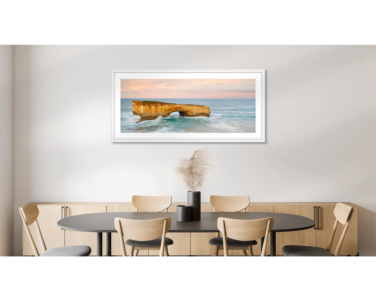 Time Out. Large wall art print of London Bridge, with a white frame, hung in a dining room. 