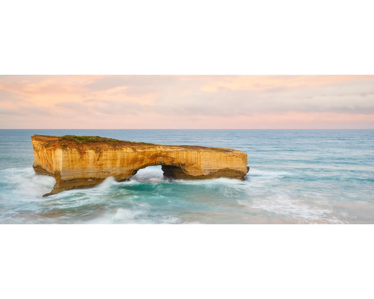 Time Out. London Bridge on the Great Ocean Road, with a pink sunrise.