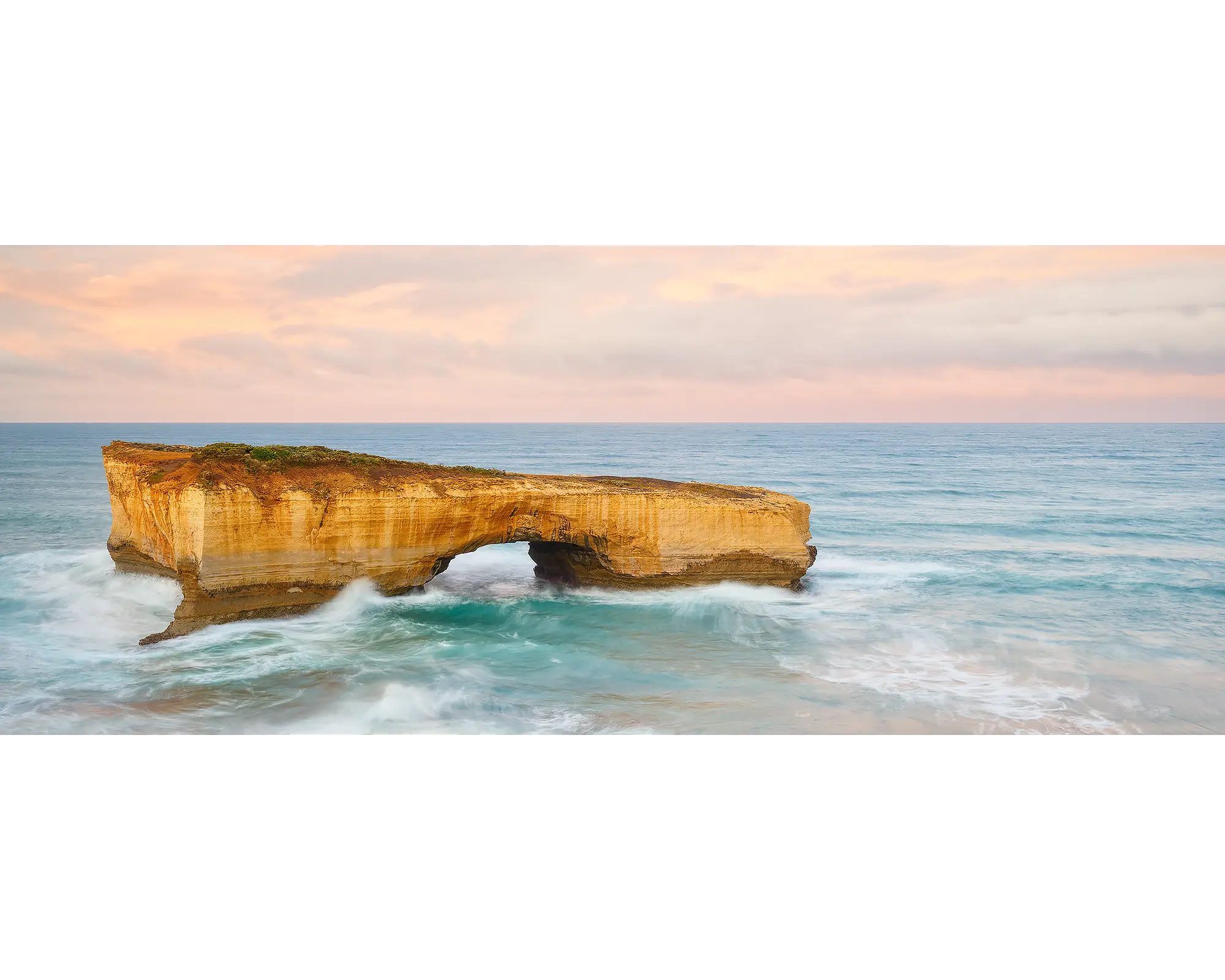 Time Out. London Bridge on the Great Ocean Road, with a pink sunrise.