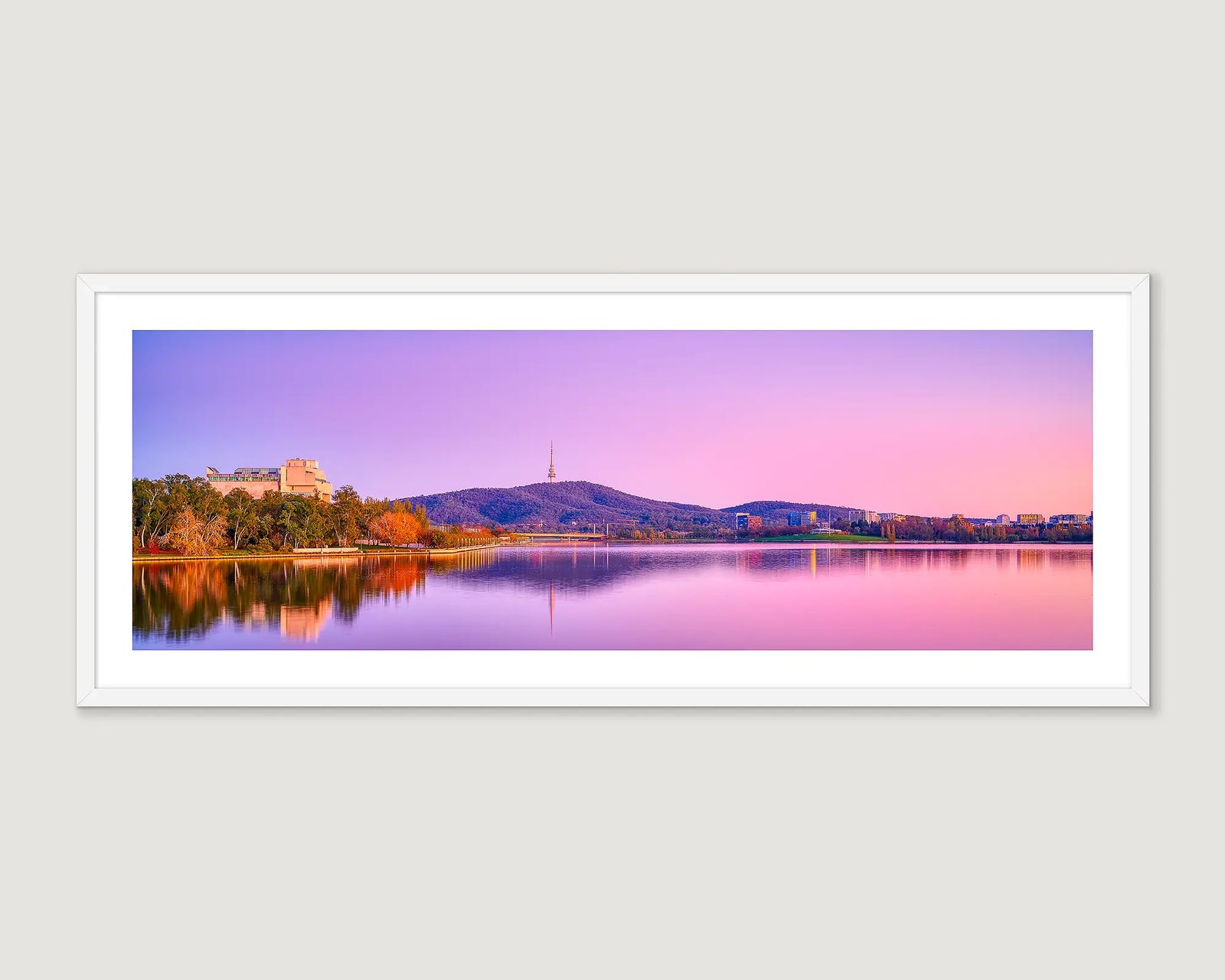 Framed panoramic landscape of Lake Burley Griffin with Black Mountain and a buildings at sunrise.