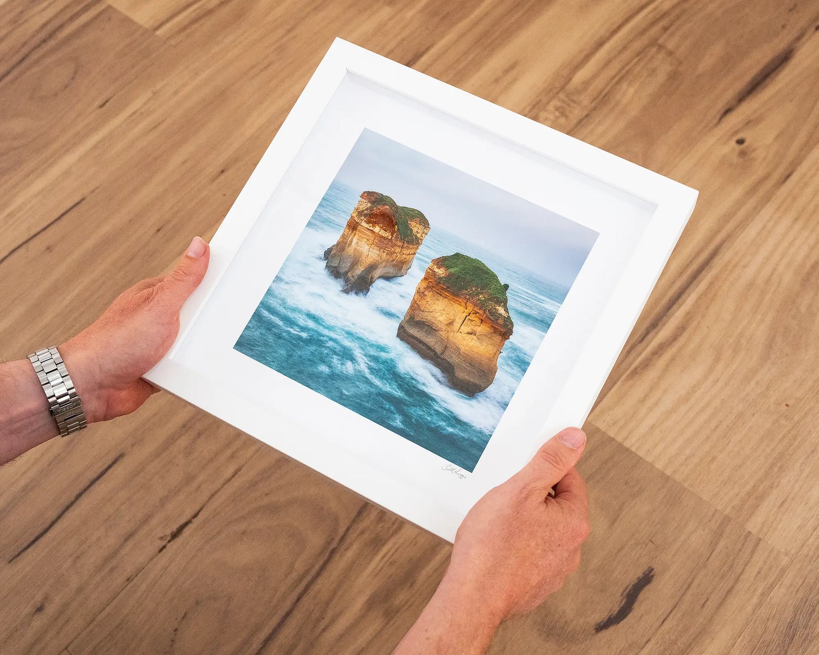 Framed photograph of two rock formations at the Great Ocean Road in the ocean with a white frame.