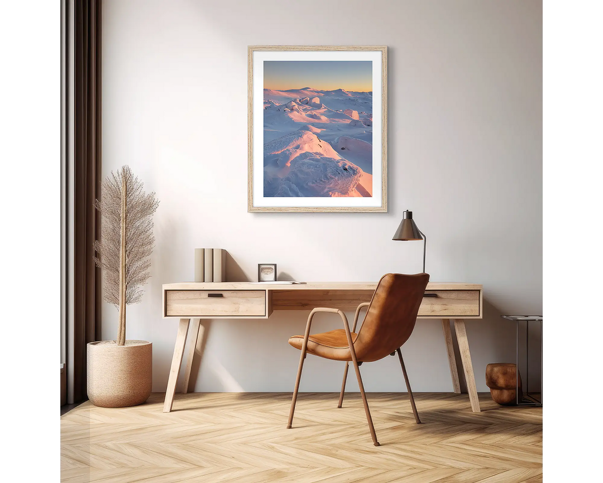 Tones of Kosciuszko. Wall art print of a sunrise over Mount Kosciuszko framed with a timber frame and hung in an apartment above a desk. 