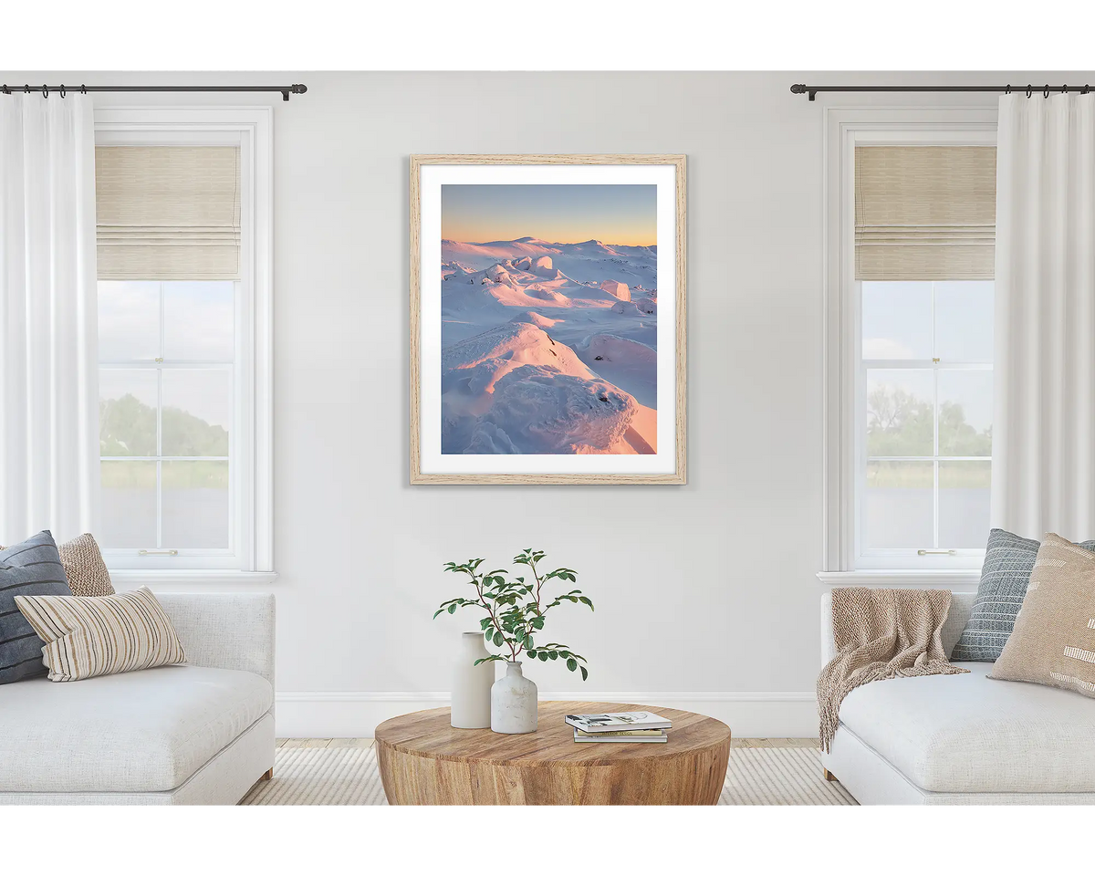 Tones of Kosciuszko. Wall art print of a sunrise over Mount Kosciuszko framed with a timber frame and hung on a lounge room wall. 