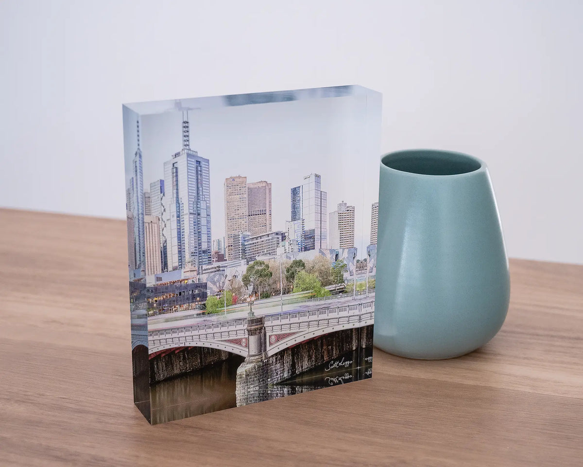 Top End. Acrylic block of Melbourne city views, styled with a small vase on a desk.