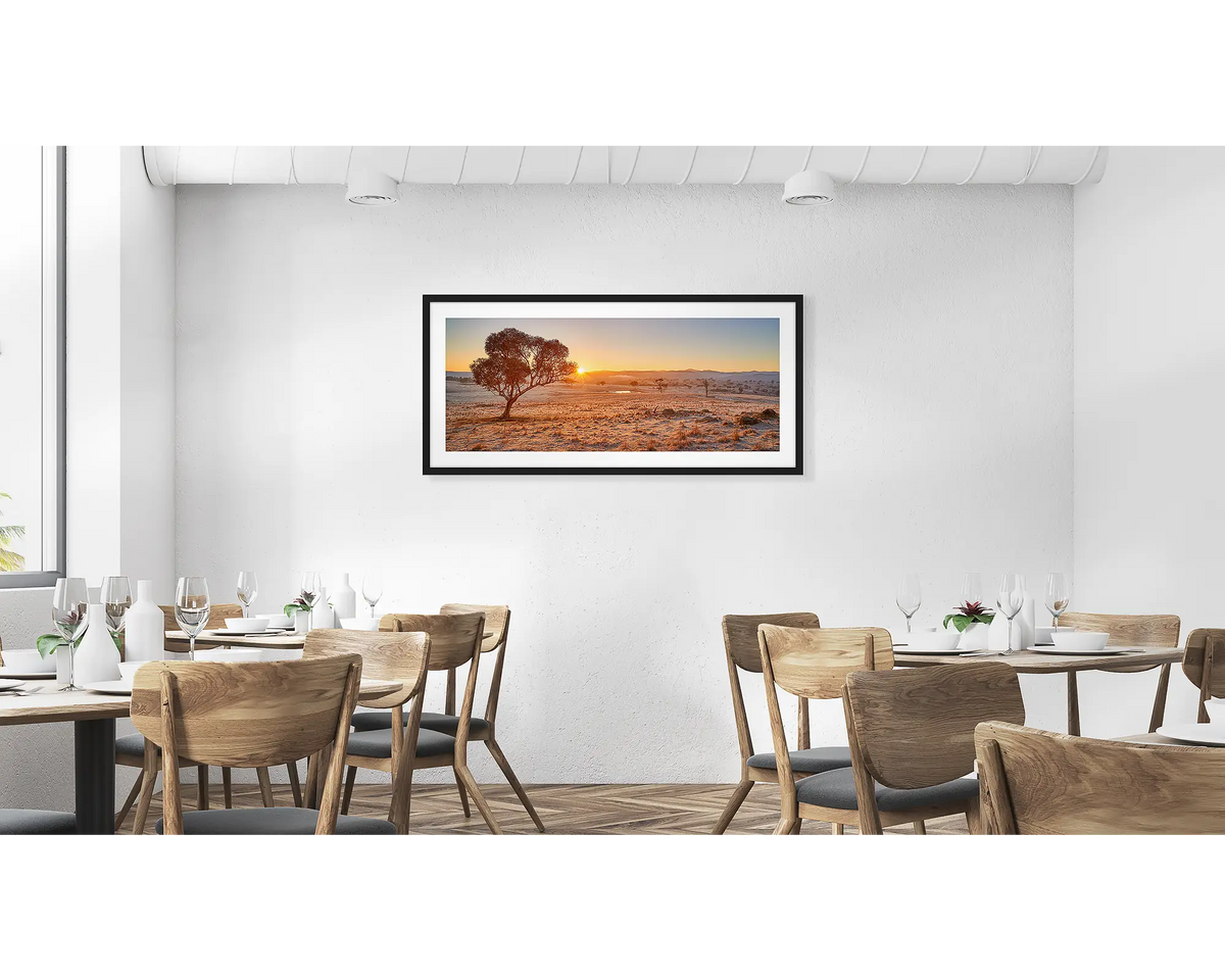Touching the Sun. Googong Sunrise wall art in a black frame hung in a cafe. 