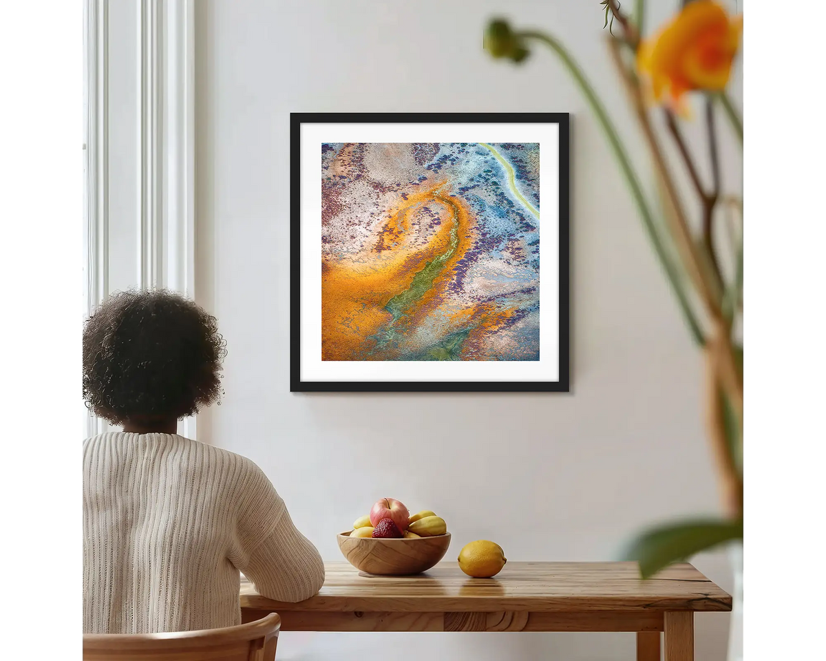 Trails. Roebuck Plains photographic wall art print with a black frame, hung on a kitchen wall with a woman admiring. 