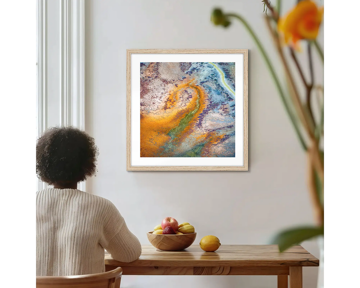 Trails. Roebuck Plains photographic wall art print with a timber frame, hung on a kitchen wall with a woman admiring. 