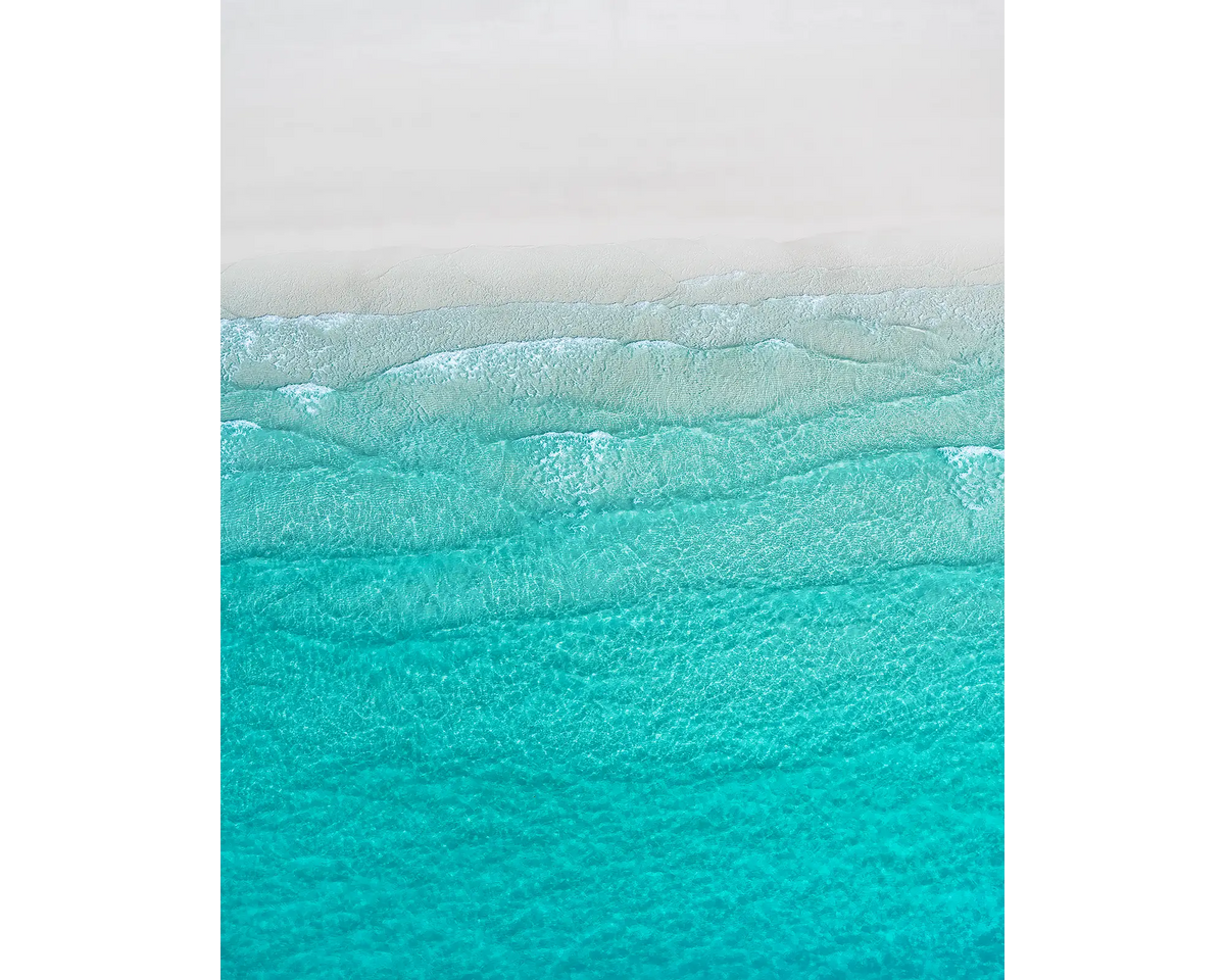 Tranquility - Aerial view of waves and white sand at Whitehaven Beach, Whitsunday Island, Queensland, Australia.