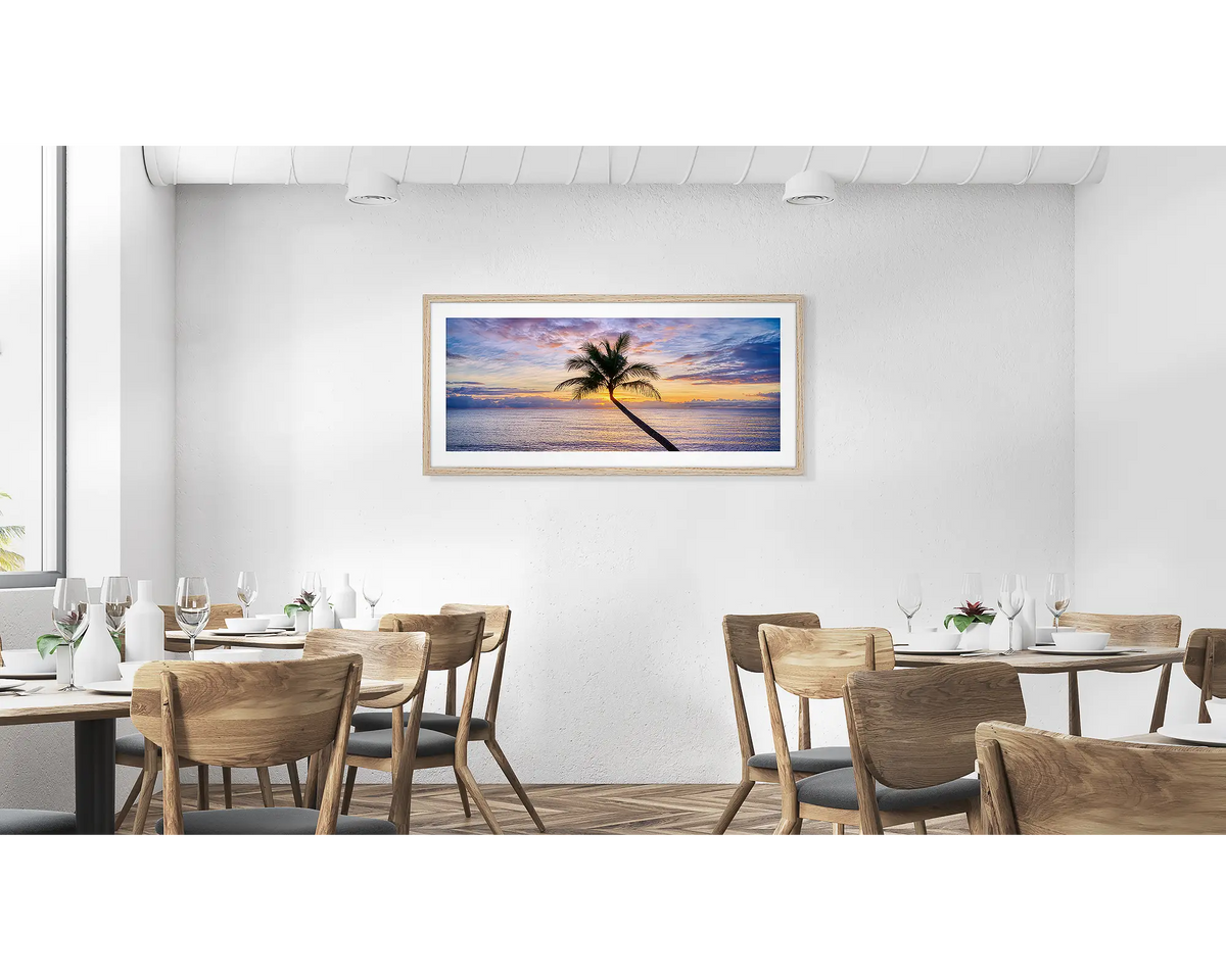 Tropical Icon. Cairns palm tree wall art print in a timber frame, hung in a cafe. 