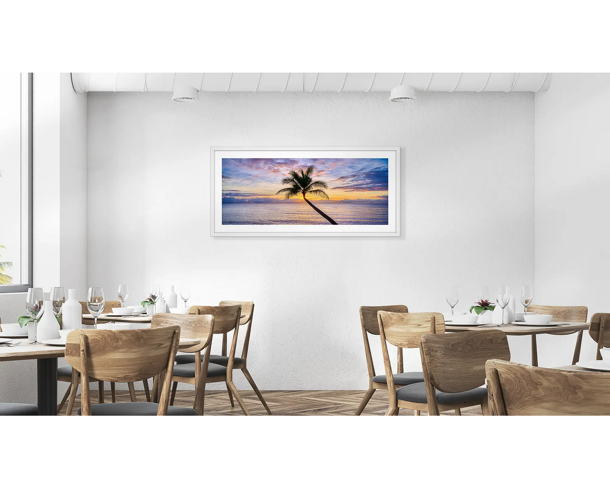 Tropical Icon. Cairns palm tree wall art print in a white frame, hung in a cafe. 