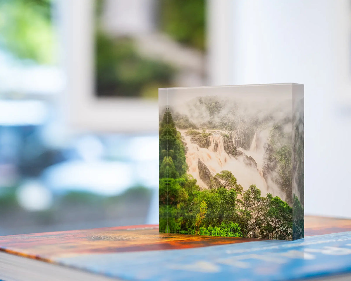 Tropical Pour. Acrylic block Barron Falls, Queensland, in gallery placed on SCOTT LEGGO Australia book, and waterfall artwork in background.