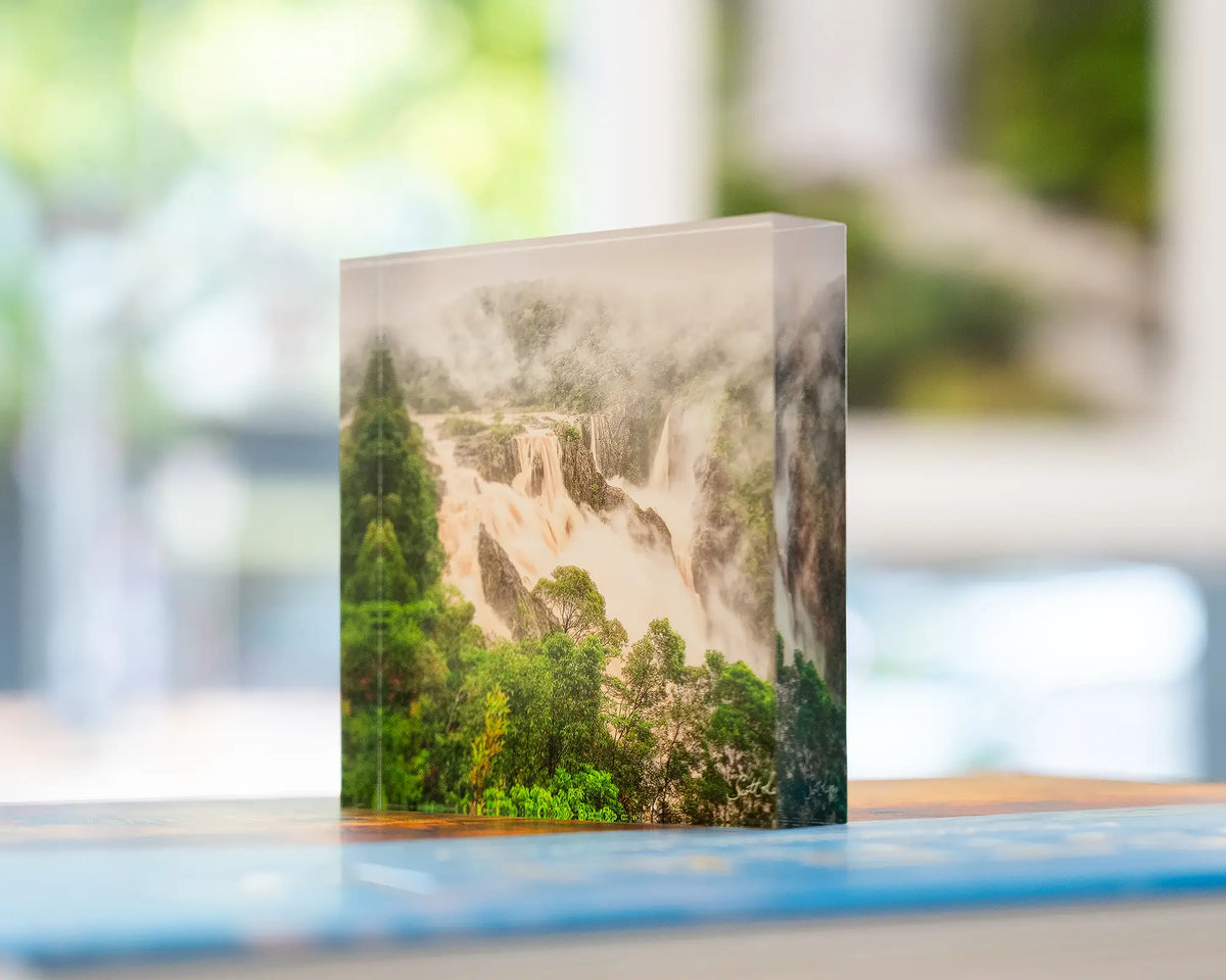 Tropical Pour. Acrylic block Barron Falls, Queensland, placed on SCOTT LEGGO Australia book with window and waterfall artwork behind.