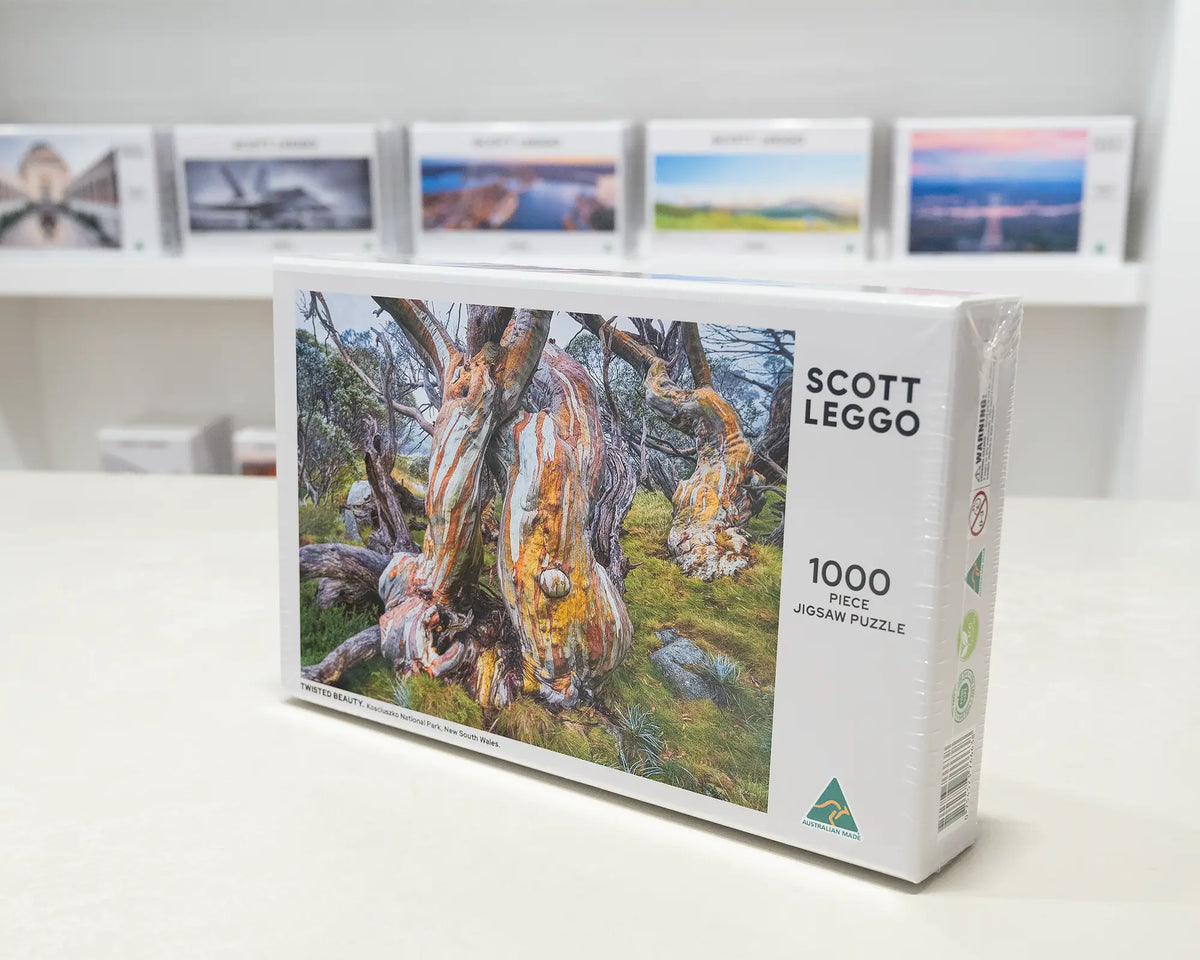 Twisted Beauty. 1000 piece snow gum jigsaw puzzle box standing on desk in gallery.