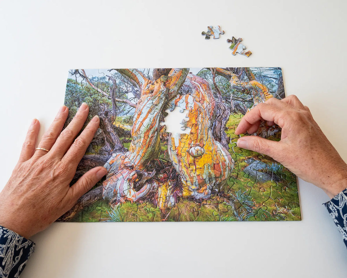 Twisted Beauty. 120 piece jigsaw puzzle of a colourful snow gum being assembled. 