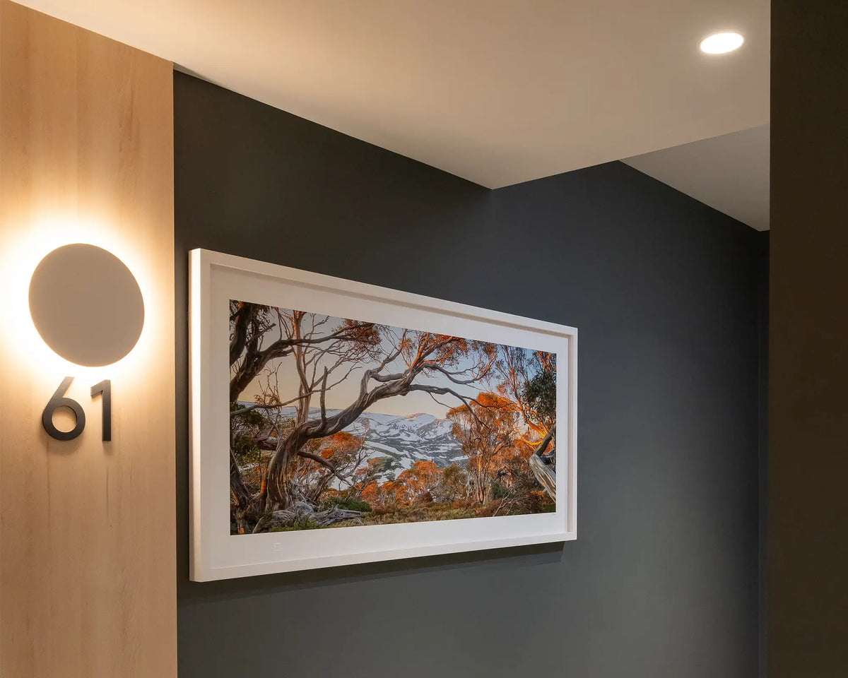 Twynam's View. Snow on Mount Twynam, Kosciuszko National Park, with white frame on charcoal grey wall in apartment building.